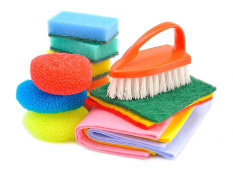 Local cleaner maintaining a Greenwich apartment kitchen and living area