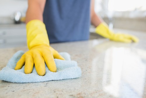 Cleaner preparing a kitchen in a Greenwich property before move-in